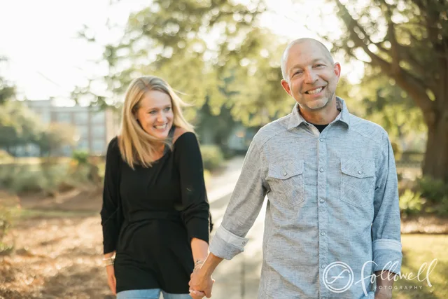The podcast hosts walking hand-in-hand
